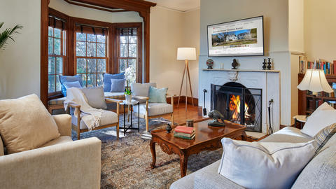 Howells House living room with ample cozy seating, views, and a fireplace