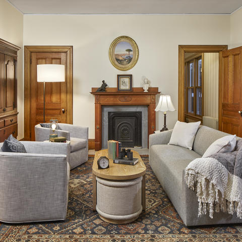 Cozy seating area with a couch and two love seats, fireplace