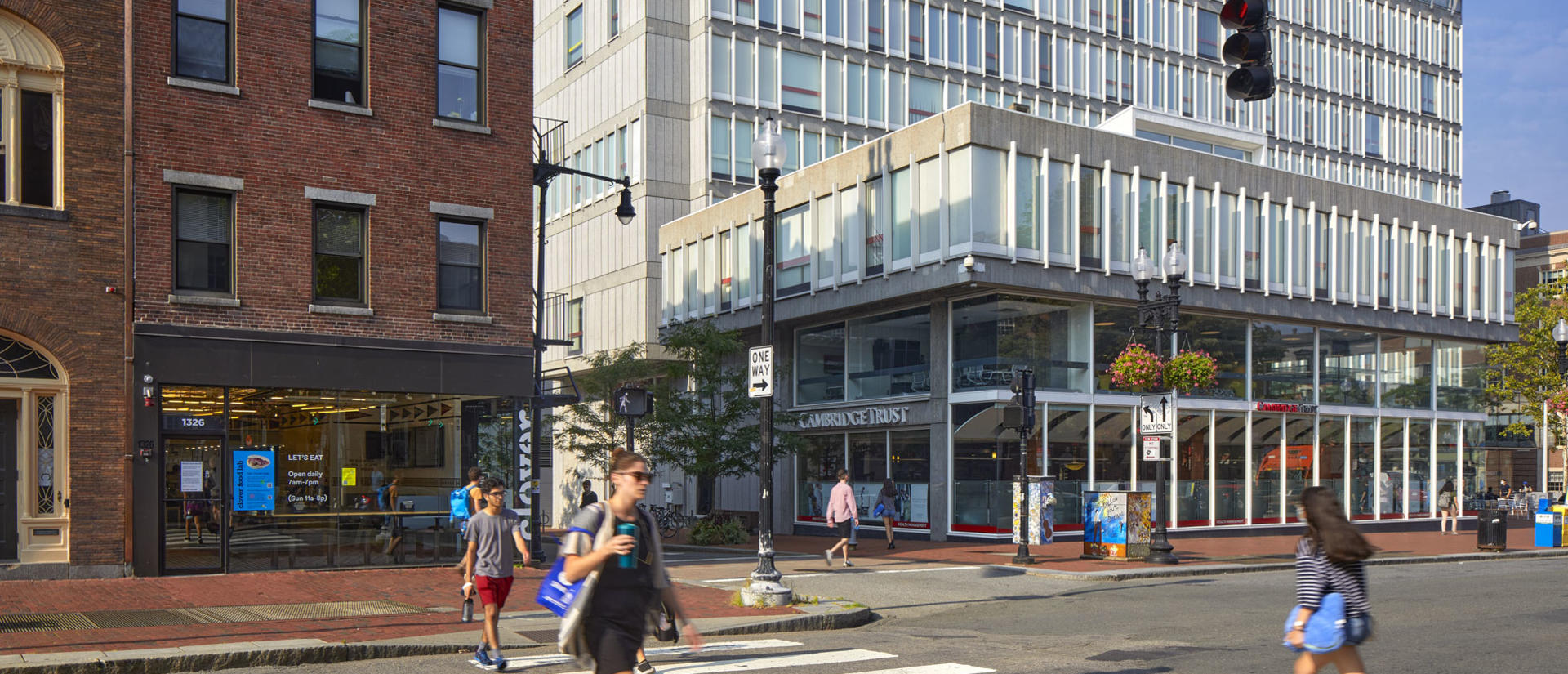 The facade of Smith Campus Center on a sunny day with people walking around