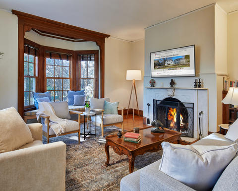 Howells House living room with ample cozy seating, views, and a fireplace